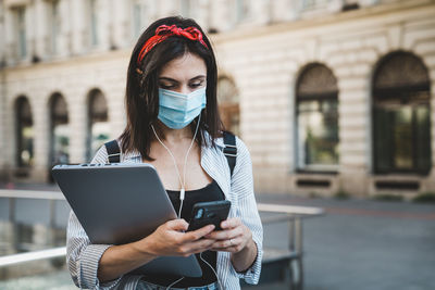 Woman using mobile phone outdoors