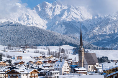 High angle view of townscape and snowcapped mountains