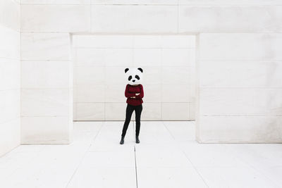 Full length of child standing on floor against wall