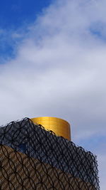 Low angle view of building against cloudy sky