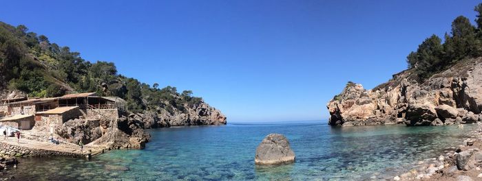 Scenic view of sea against clear blue sky