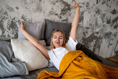 Portrait of young woman sleeping on bed at home