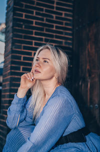 Portrait of young woman sitting outdoors