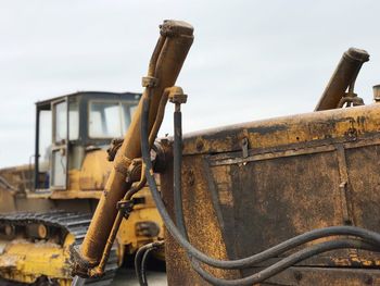 Rusty earth mover against clear sky