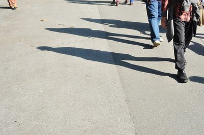 Low section of people walking on road