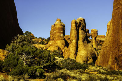 Low angle view of rock formation against clear sky