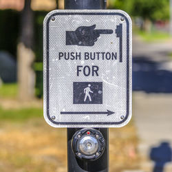 Close-up of arrow sign on road