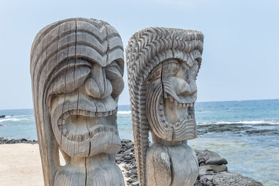 Sculpture by sea against sky