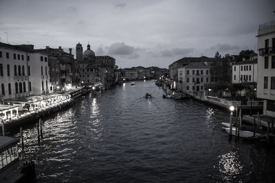 Grand canal amidst buildings in city against sky