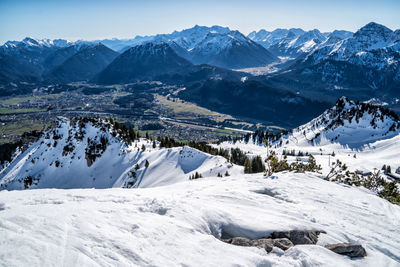 Scenic view of snow covered mountains against sky