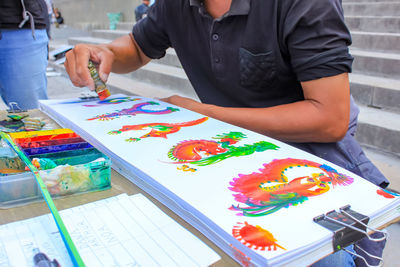 Low angle view of man painting on table