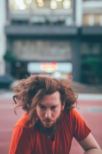 Portrait of smiling woman standing against wall