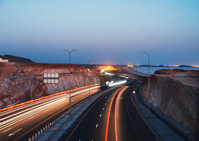 High angle view of light trails on highway in city