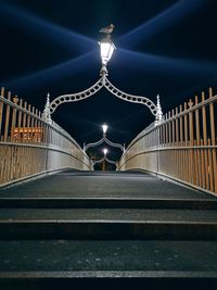 Illuminated footbridge at night