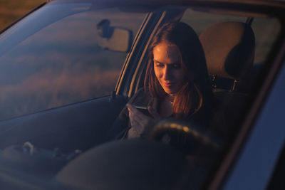 Portrait of woman sitting in car