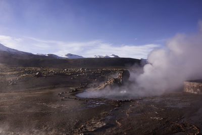 Scenic view of hot spring against sky