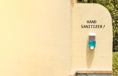 Sanitizer with text on wall