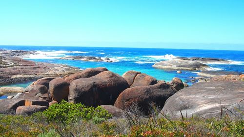 Panoramic view of sea against clear blue sky