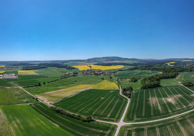 Aerial view of agricultural field against clear blue sky