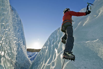 Woman climbing on the fjallsjökull glacier in iceland