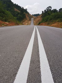 Road by mountain against sky