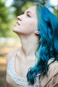 Close-up of young woman looking away outdoors