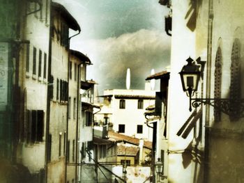 Buildings against cloudy sky