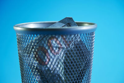 Close-up of metallic structure against blue sky