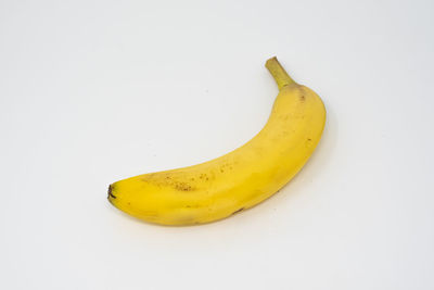 High angle view of yellow fruit against white background