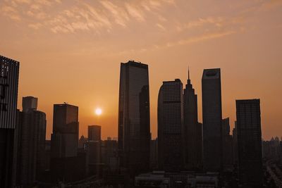 View of modern buildings against sky during sunset