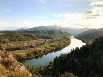 Scenic view of lake and mountains against sky