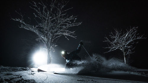 Person skiing on snow at night