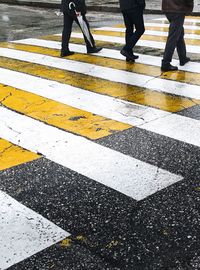 Low section of people walking on road