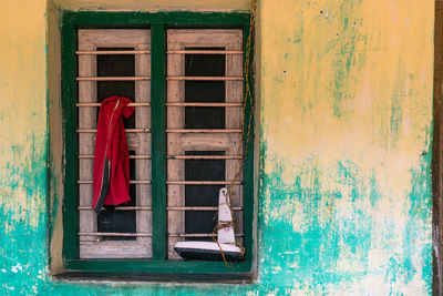 Rear view of clothes hanging on window of building