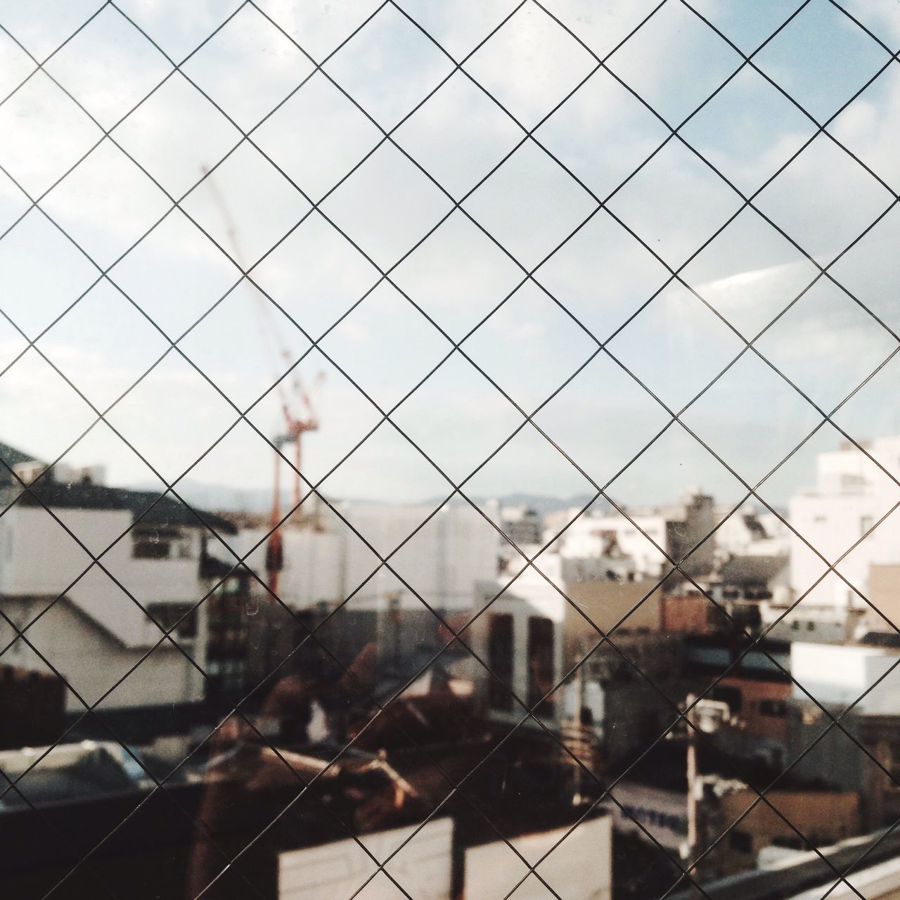 building exterior, architecture, built structure, sky, city, cloud - sky, window, cityscape, glass - material, residential structure, cloudy, fence, chainlink fence, day, transparent, cloud, indoors, residential building, building, house