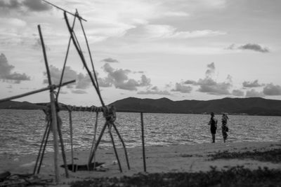 People on beach against sky