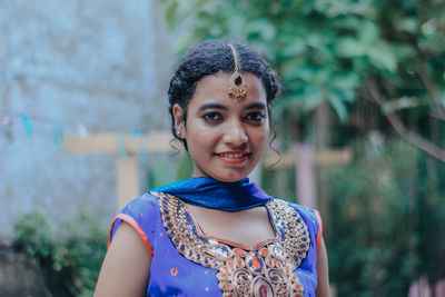 Portrait of woman wearing traditional clothing and jewelry