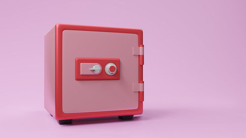 Close-up of telephone booth against pink background