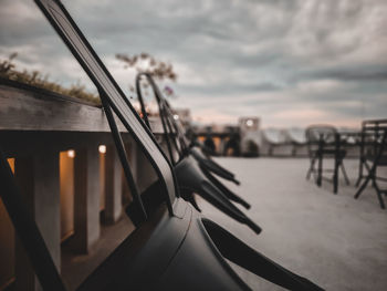 Close-up of railing against sky during sunset