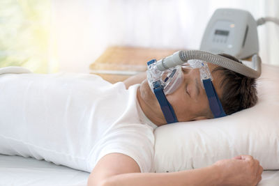 Close-up of boy lying on bed