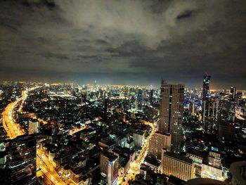 Aerial view of city lit up at night