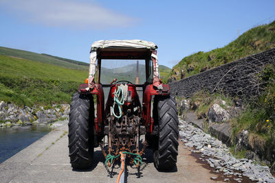 Rear view of a truck on road against mountain