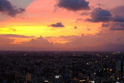 High angle view of buildings against cloudy sky during sunset