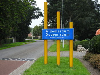 Road sign by trees