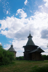 Building on field against sky