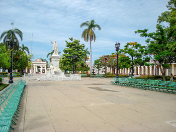 Fountain in front of building against sky