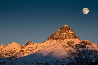 Scenic view of snowcapped mountains against clear sky during sunset. engadin. switzerland