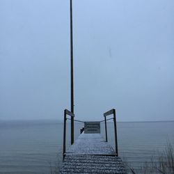 Pier over sea against clear sky