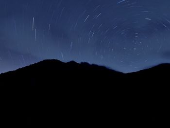 Scenic view of mountains against sky at night