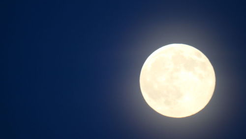 Low angle view of moon against clear sky at night